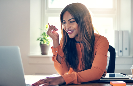 Female travel booker sitting at laptop