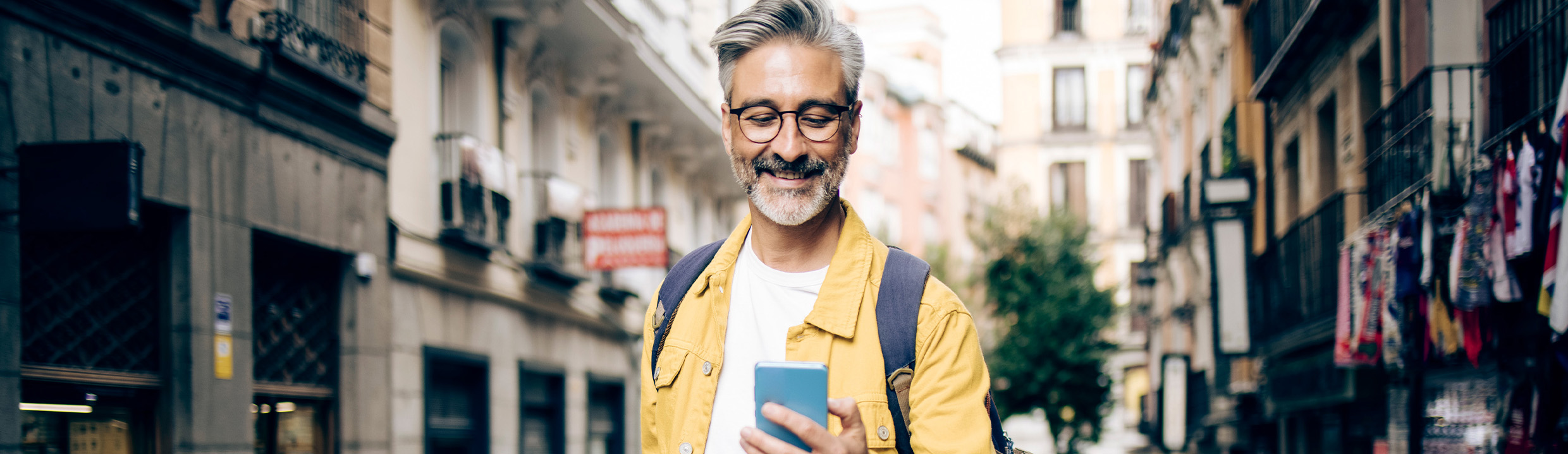 Contact 1000 Mile Travel Escapes - man looking at mobile phone